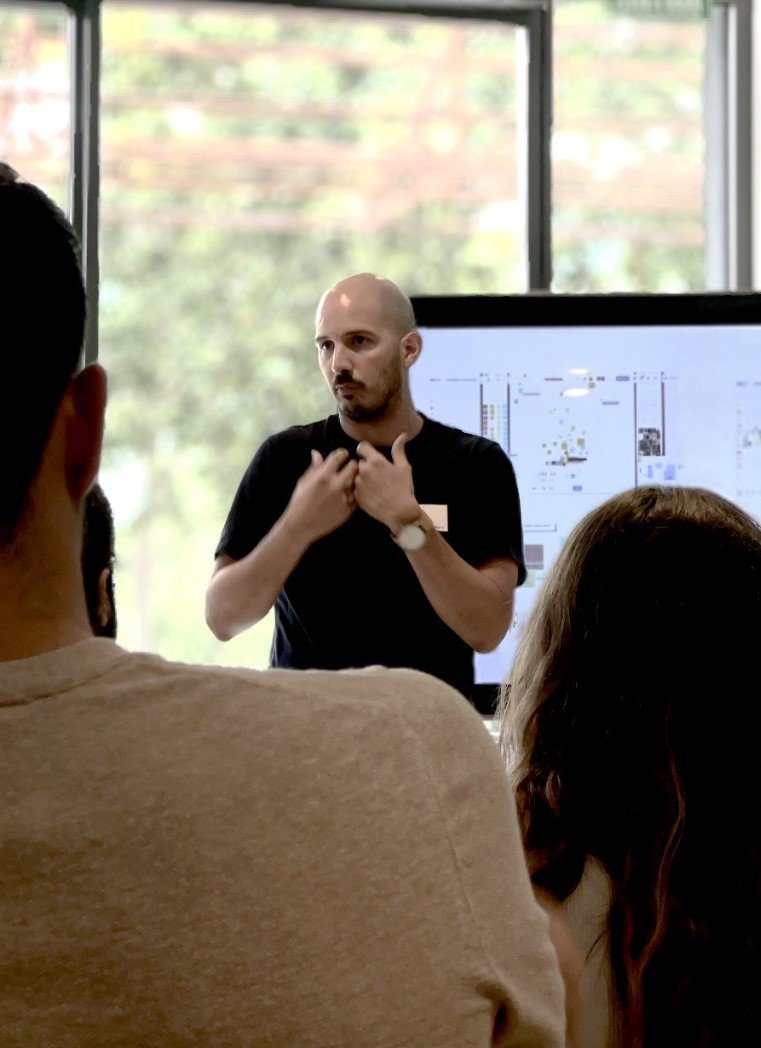 Andrés Cruz presenting research findings to a team